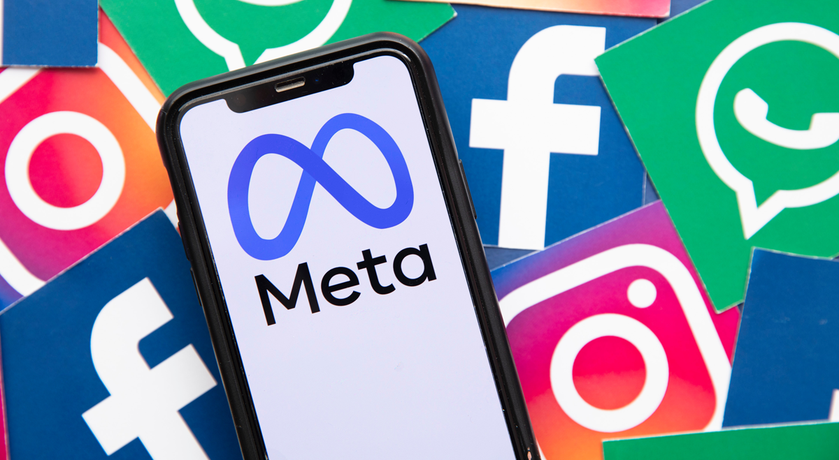 Phone with Meta on screen, Facebook and Instagram logos