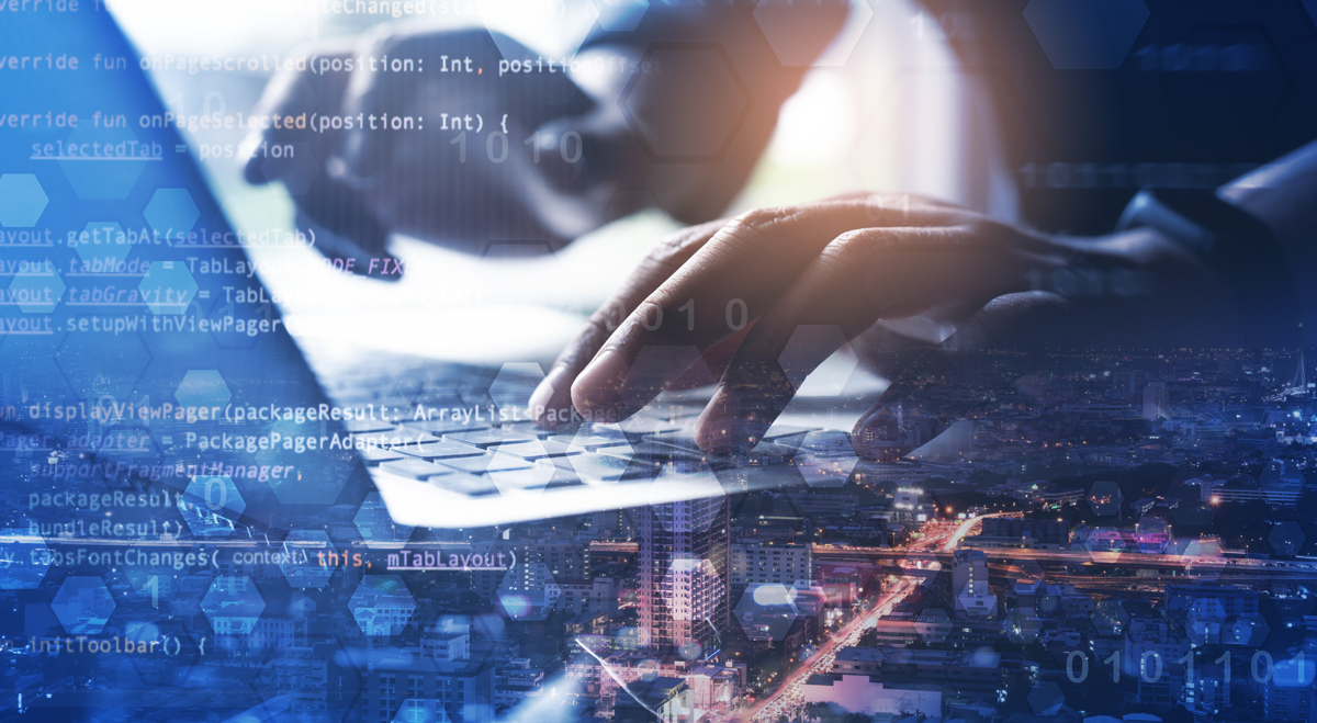 Hands writing software on a keyboard